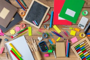Back to school concept. School supplies on wooden background, top view