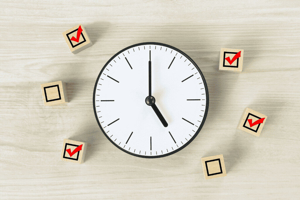 時計とチェックマーク付きブロックが並ぶ、引っ越し準備のスケジュール管理を示す写真